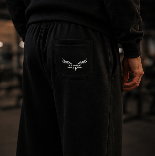 Back view of a person wearing Respire Alpine Sweats featuring a pocket with the Respire logo.