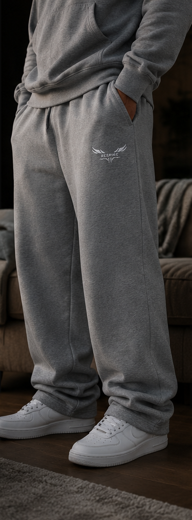 Model wearing Respire Alpine Sweats in grey cotton terry, featuring a relaxed fit and paired with white sneakers.